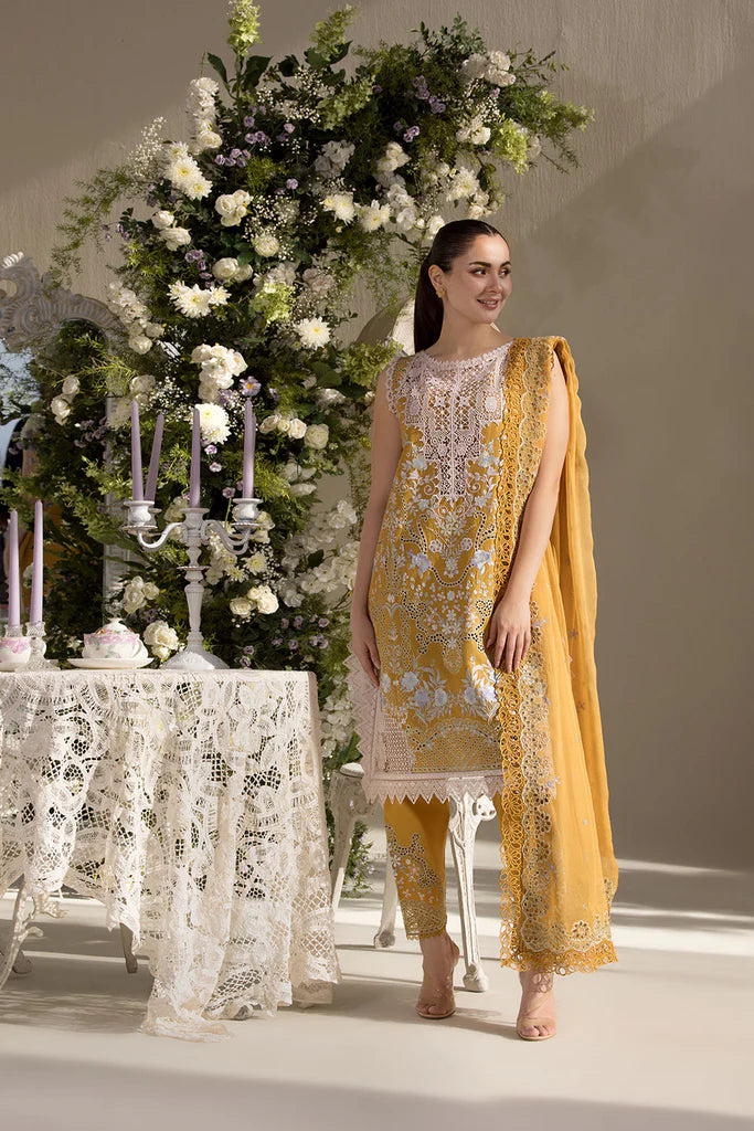 Model wearing Sobia Nazir Design 6B mustard yellow luxury lawn dress with intricate embroidery. Shop Pakistani clothes online in the UK for casual and festive wear.
