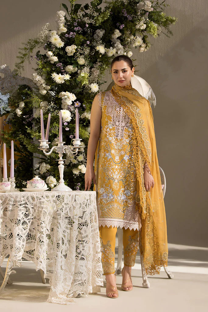 Model wearing Sobia Nazir Design 6B mustard yellow luxury lawn dress with intricate embroidery. Shop Pakistani clothes online in the UK for casual and festive wear.
