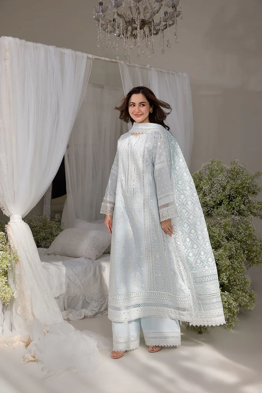 Model wearing Sobia Nazir Design 7A white luxury lawn dress with intricate embroidery. Shop Pakistani clothes online in the UK for casual and festive wear.