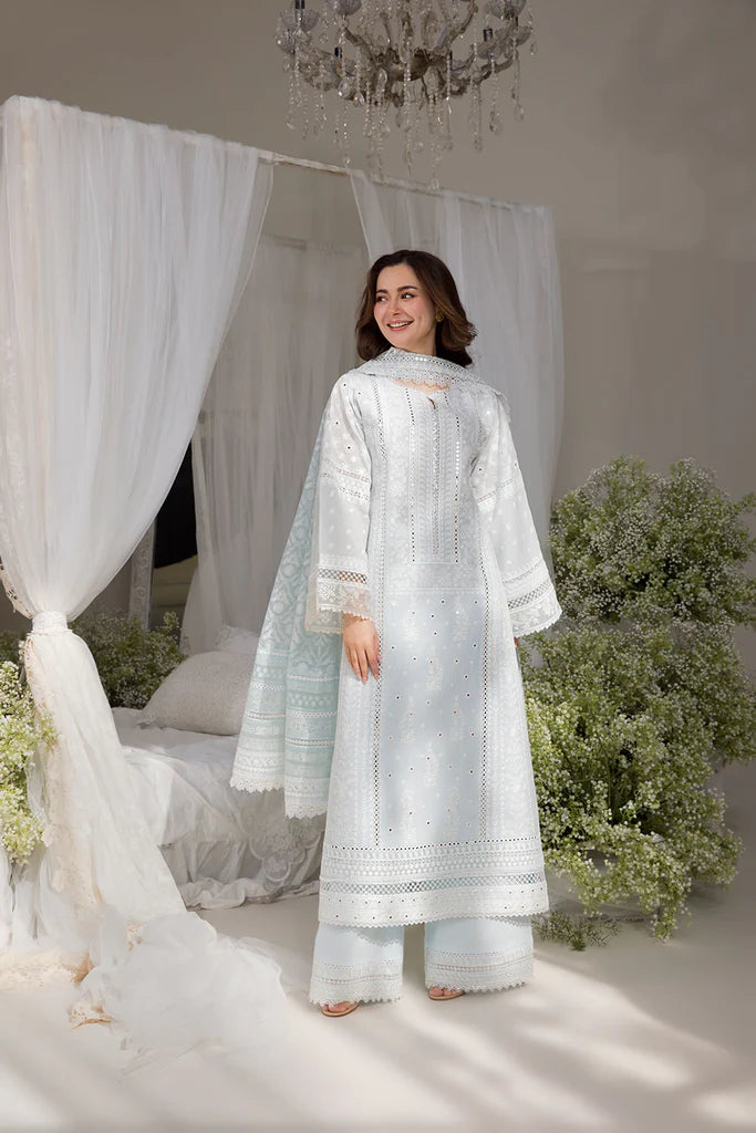 Model wearing Sobia Nazir Design 7A white luxury lawn dress with intricate embroidery. Shop Pakistani clothes online in the UK for casual and festive wear.