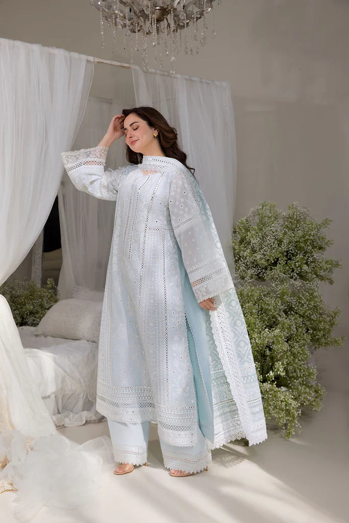 Model wearing Sobia Nazir Design 7A white luxury lawn dress with intricate embroidery. Shop Pakistani clothes online in the UK for casual and festive wear.