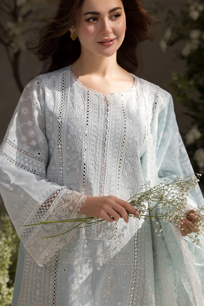 Model wearing Sobia Nazir Design 7A white luxury lawn dress with intricate embroidery. Shop Pakistani clothes online in the UK for casual and festive wear.