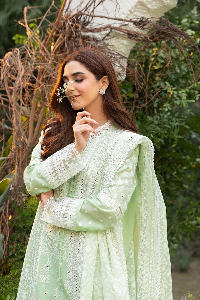 Model wearing Sobia Nazir Design 7B pastel green luxury lawn dress with delicate embroidery. Shop Pakistani clothes online in the UK for casual and festive wear.
