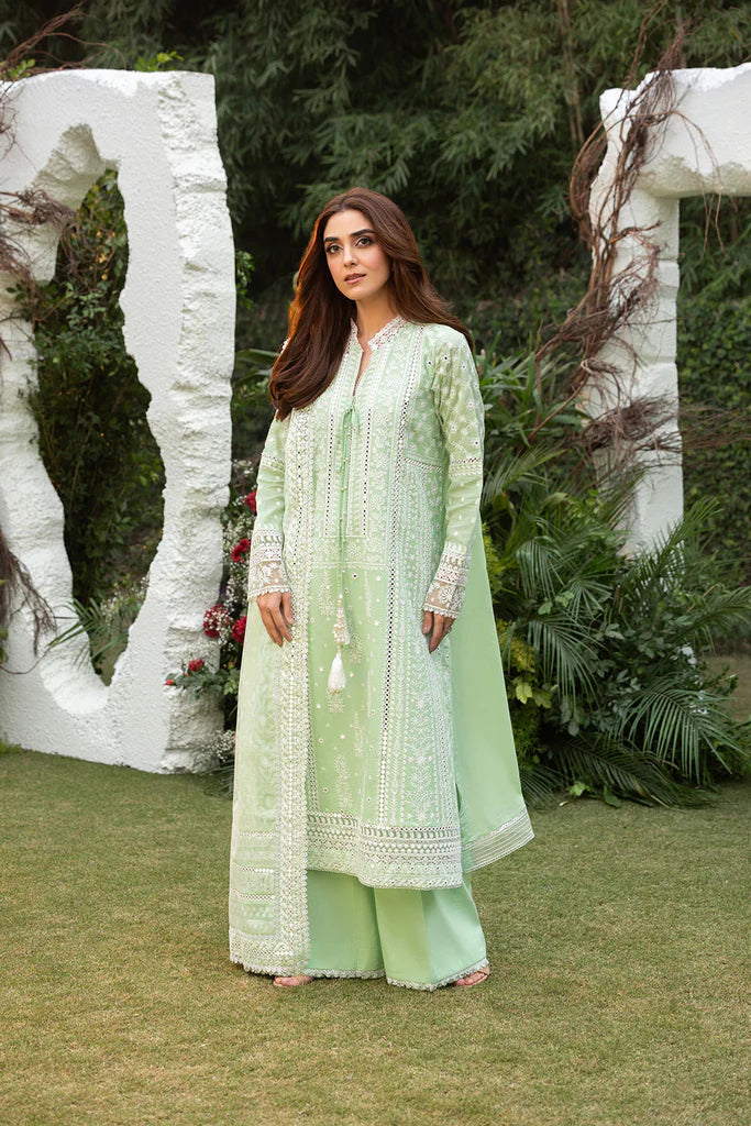 Model wearing Sobia Nazir Design 7B pastel green luxury lawn dress with delicate embroidery. Shop Pakistani clothes online in the UK for casual and festive wear.
