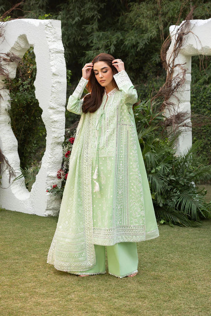 Model wearing Sobia Nazir Design 7B pastel green luxury lawn dress with delicate embroidery. Shop Pakistani clothes online in the UK for casual and festive wear.
