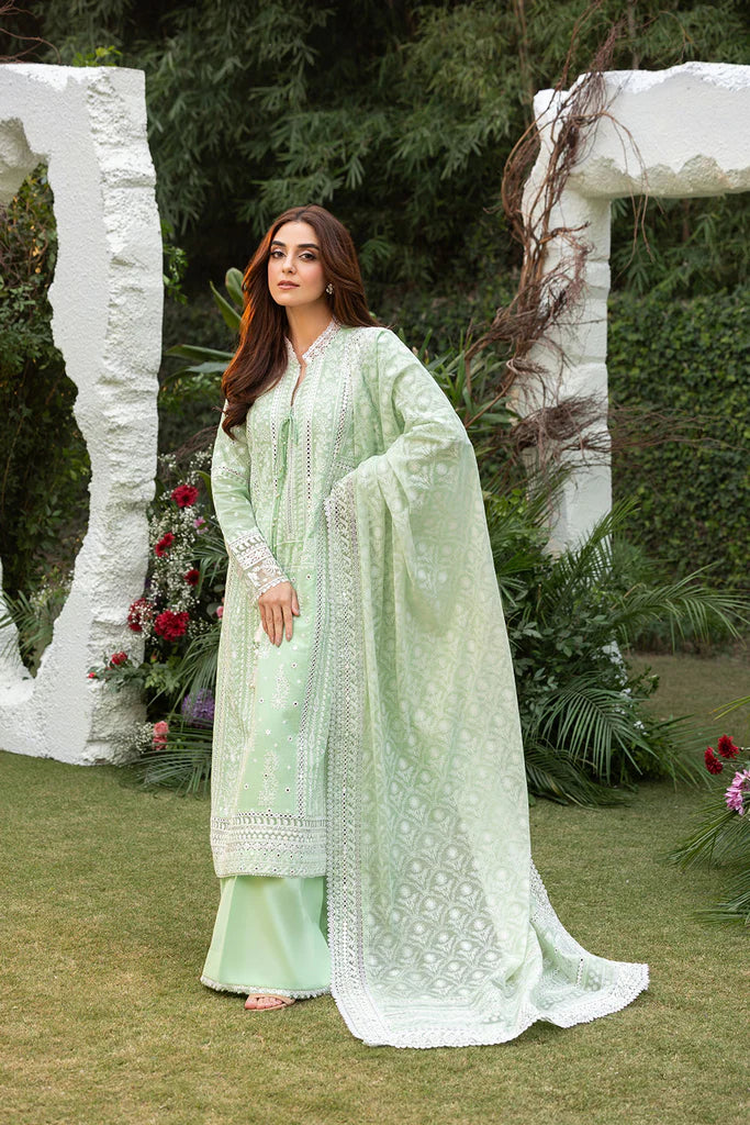 Model wearing Sobia Nazir Design 7B pastel green luxury lawn dress with delicate embroidery. Shop Pakistani clothes online in the UK for casual and festive wear.
