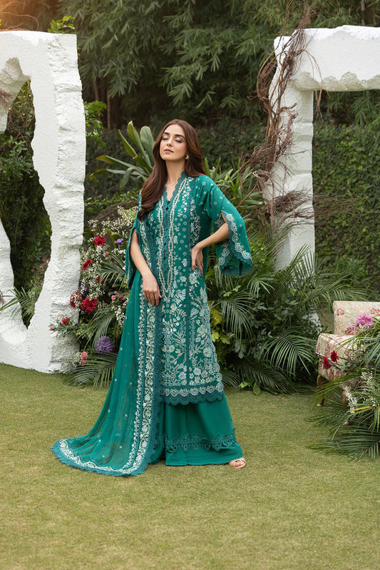 Model wearing Sobia Nazir Design 8B emerald green luxury lawn dress. Shop Pakistani clothes online in the UK for summer casual and festive wear.