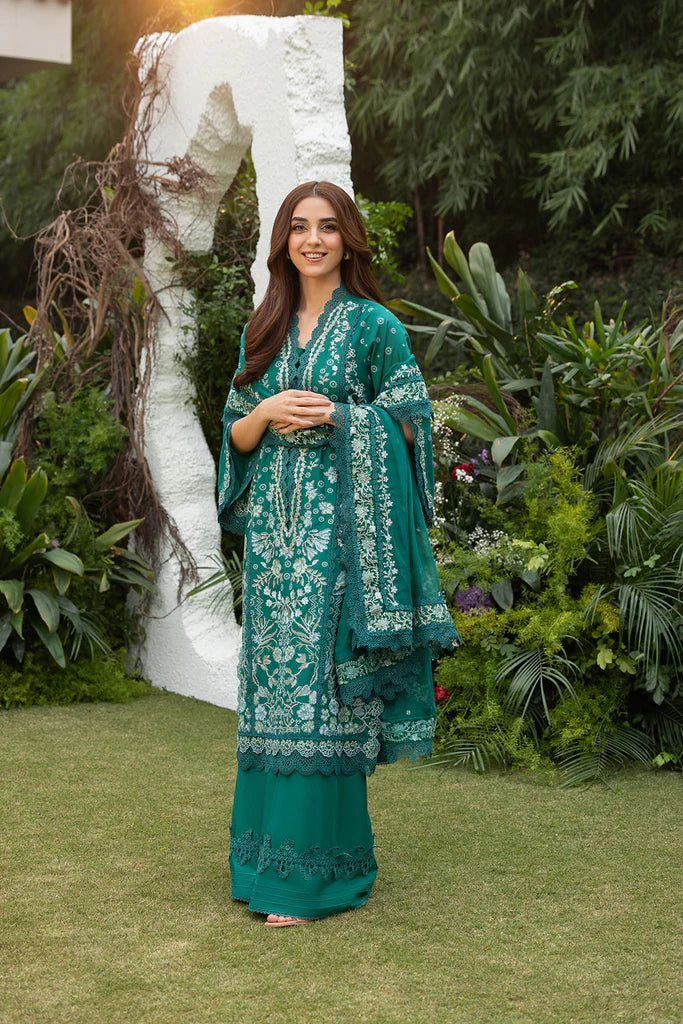 Model wearing Sobia Nazir Design 8B emerald green luxury lawn dress. Shop Pakistani clothes online in the UK for summer casual and festive wear.