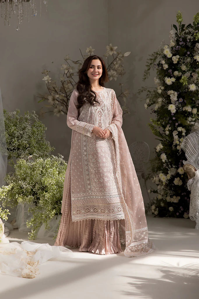 Model wearing Sobia Nazir Design 9A pastel pink luxury lawn dress with delicate embroidery. Shop Pakistani clothes online in the UK for casual and festive wear.