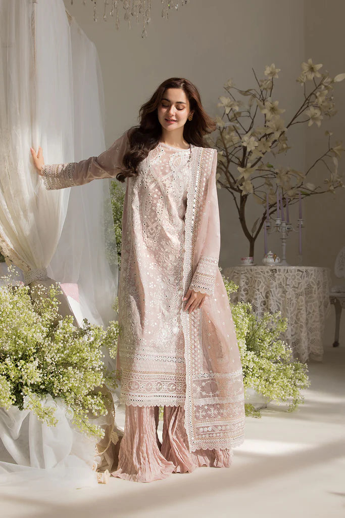 Model wearing Sobia Nazir Design 9A pastel pink luxury lawn dress with delicate embroidery. Shop Pakistani clothes online in the UK for casual and festive wear.