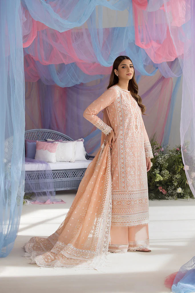 Model wearing Sobia Nazir Design 9B peach luxury lawn dress with delicate embroidery. Shop Pakistani clothes online in the UK for casual and festive wear.