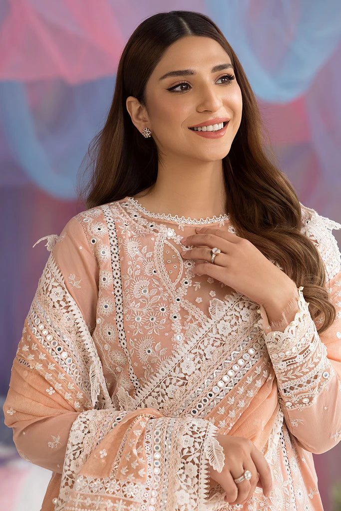 Model wearing Sobia Nazir Design 9B peach luxury lawn dress with delicate embroidery. Shop Pakistani clothes online in the UK for casual and festive wear.