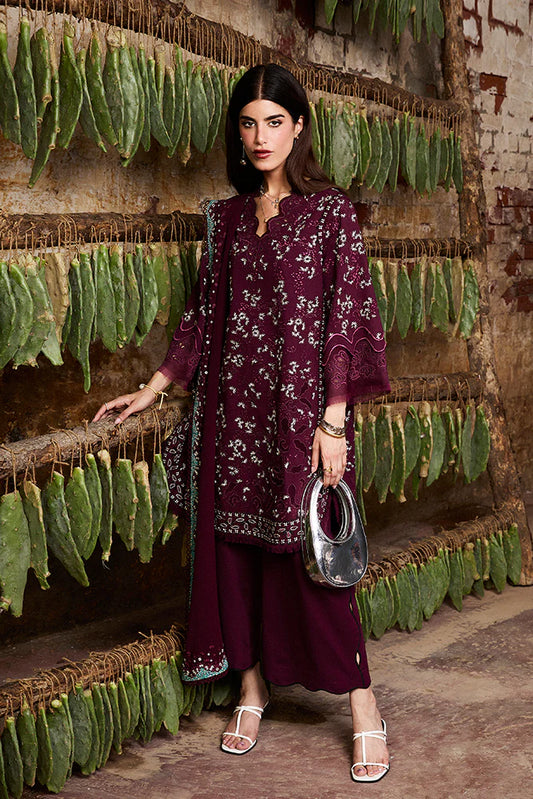 Model wearing Omya by Suffuse in deep maroon with intricate embroidery – sophisticated Pakistani luxury pret outfit in UK.