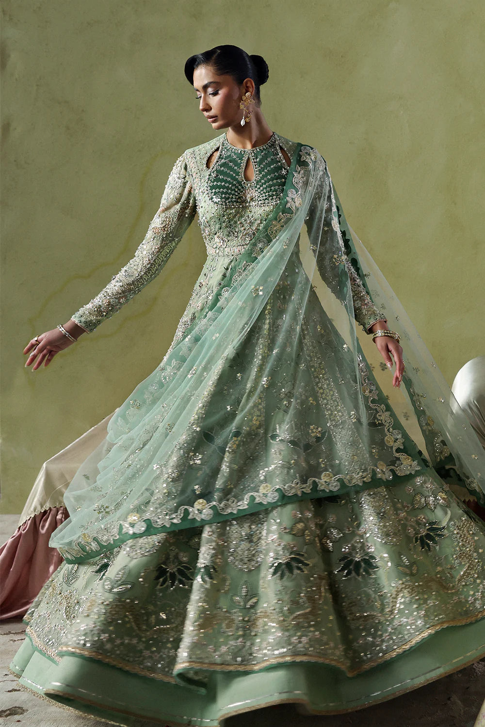 Model wearing Lirien by Soraya in pistachio green with intricate embroidery – Pakistani luxury pret, shop Pakistani clothes online in UK.
