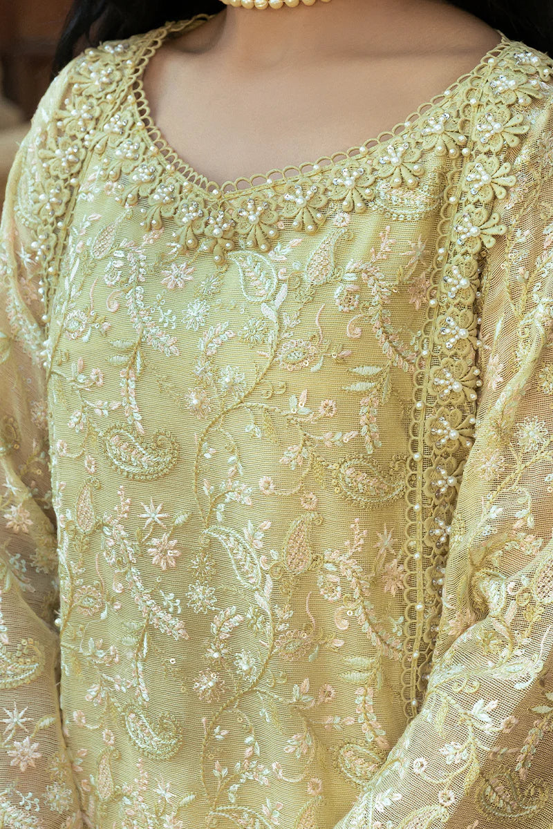 Model wearing Mushq Saugaat City of Lights Faryal in lime yellow with intricate embroidery and a white dupatta. Shop Pakistani luxury pret online in the UK.