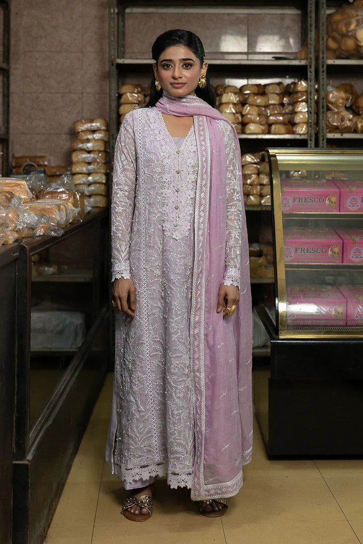 Model wearing Mushq Saugaat City of Lights Andaleeb in soft lilac with delicate embroidery and a pink dupatta. Shop Pakistani luxury pret online in the UK.