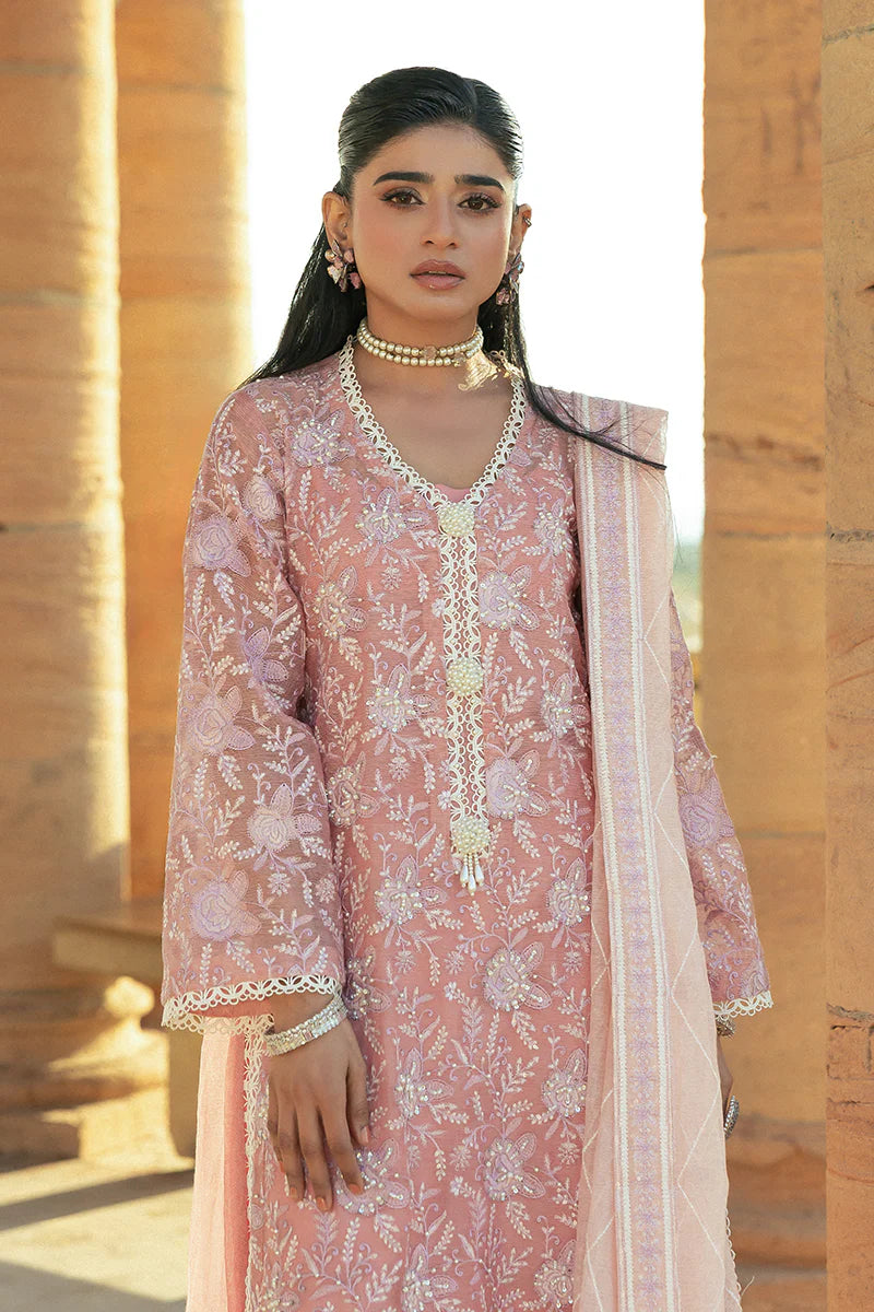 Model wearing Mushq Saugaat City of Lights Areej in soft pink with delicate embroidery and embellishments. Shop Pakistani luxury pret online in the UK.