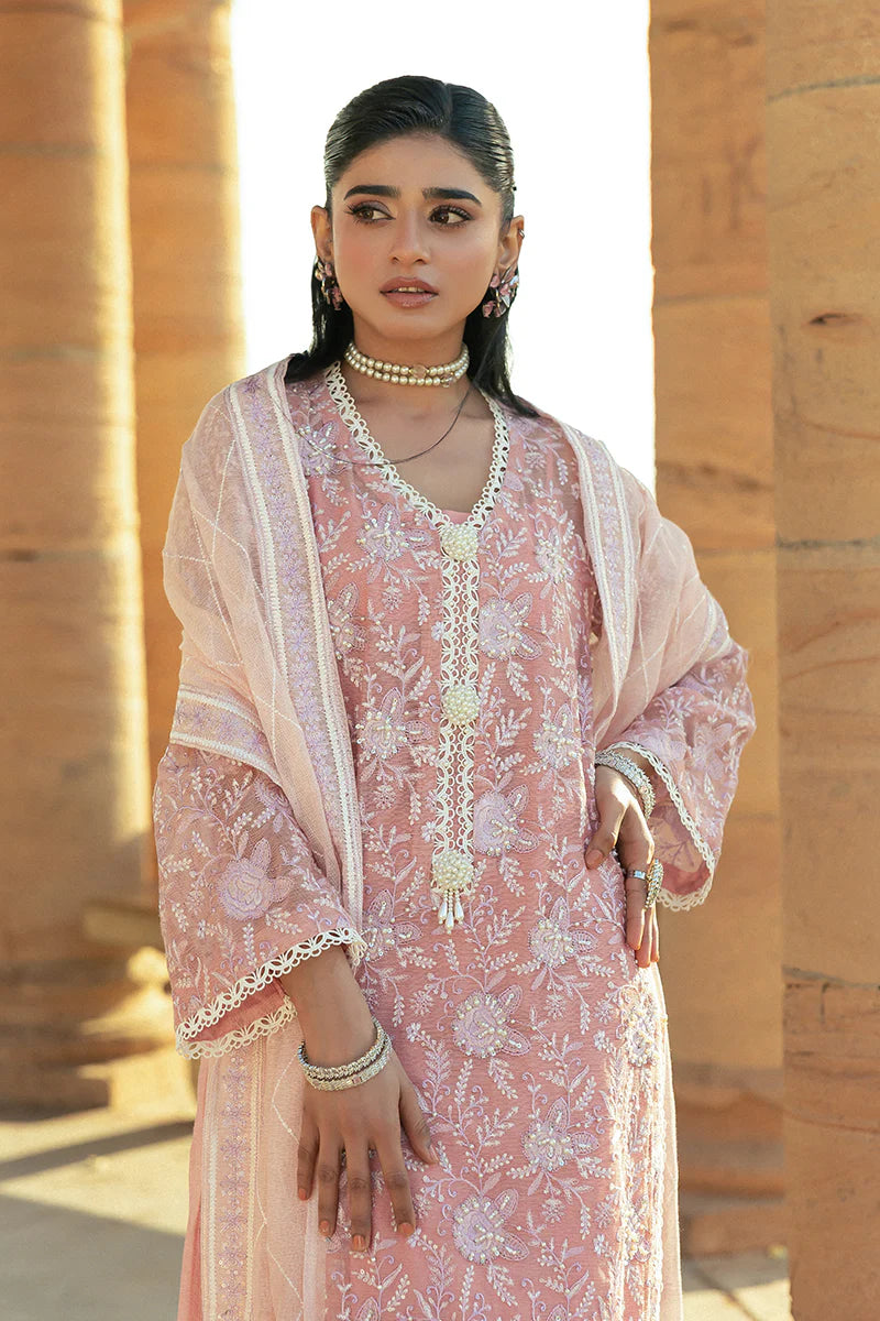 Model wearing Mushq Saugaat City of Lights Areej in soft pink with delicate embroidery and embellishments. Shop Pakistani luxury pret online in the UK.