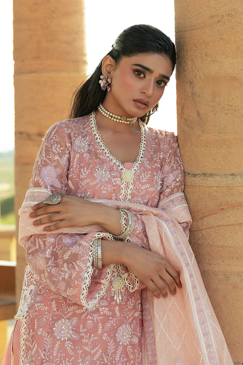 Model wearing Mushq Saugaat City of Lights Areej in soft pink with delicate embroidery and embellishments. Shop Pakistani luxury pret online in the UK.