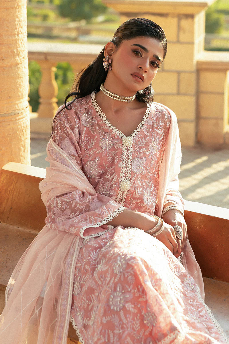 Model wearing Mushq Saugaat City of Lights Areej in soft pink with delicate embroidery and embellishments. Shop Pakistani luxury pret online in the UK.