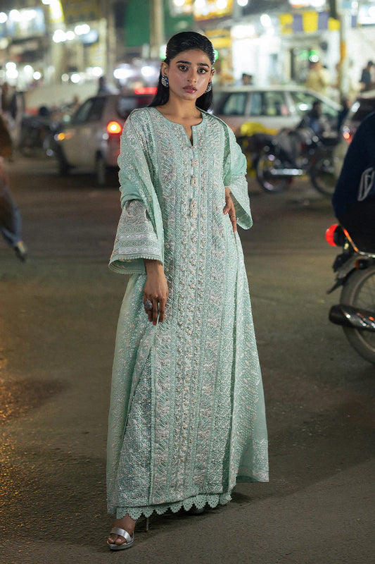 Model wearing Mushq Saugaat City of Lights Shama in mint green with intricate embroidery and embellishments. Shop Pakistani luxury pret online in the UK.