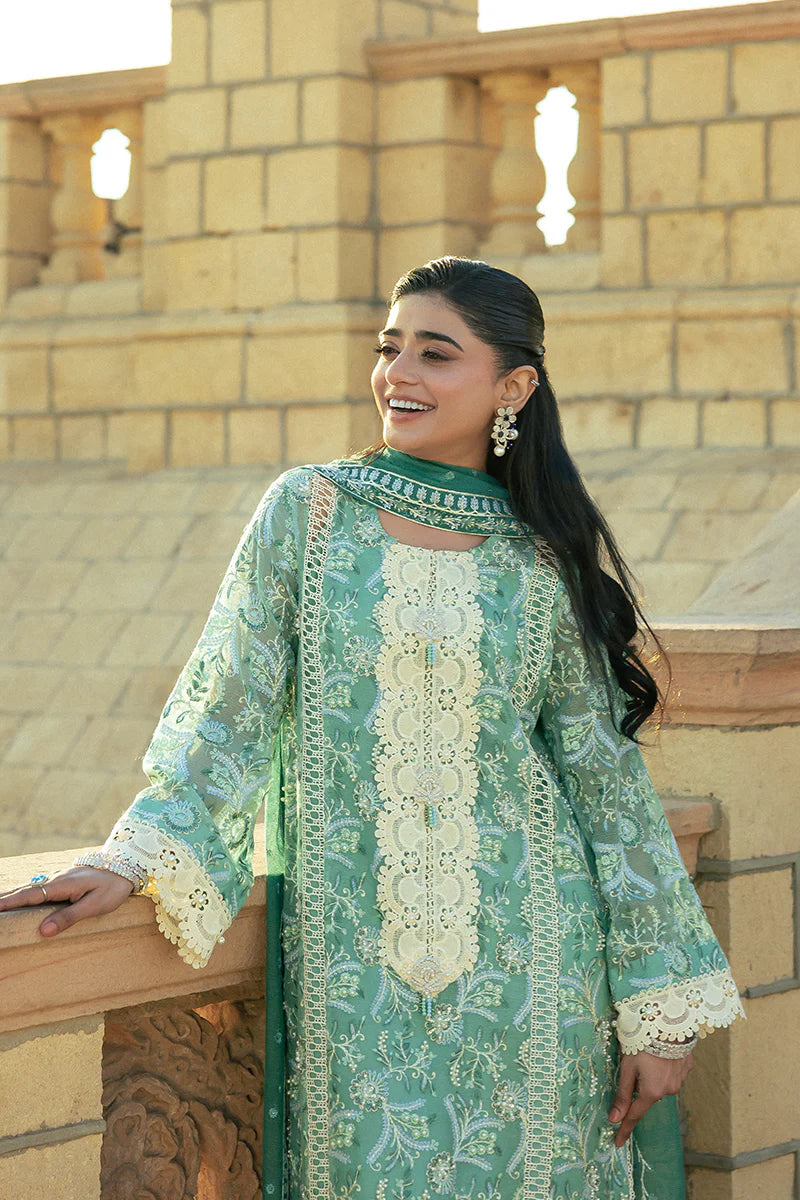 Model wearing Mushq Saugaat City of Lights Irsa in teal green with intricate embroidery. Shop Pakistani luxury pret online in the UK.