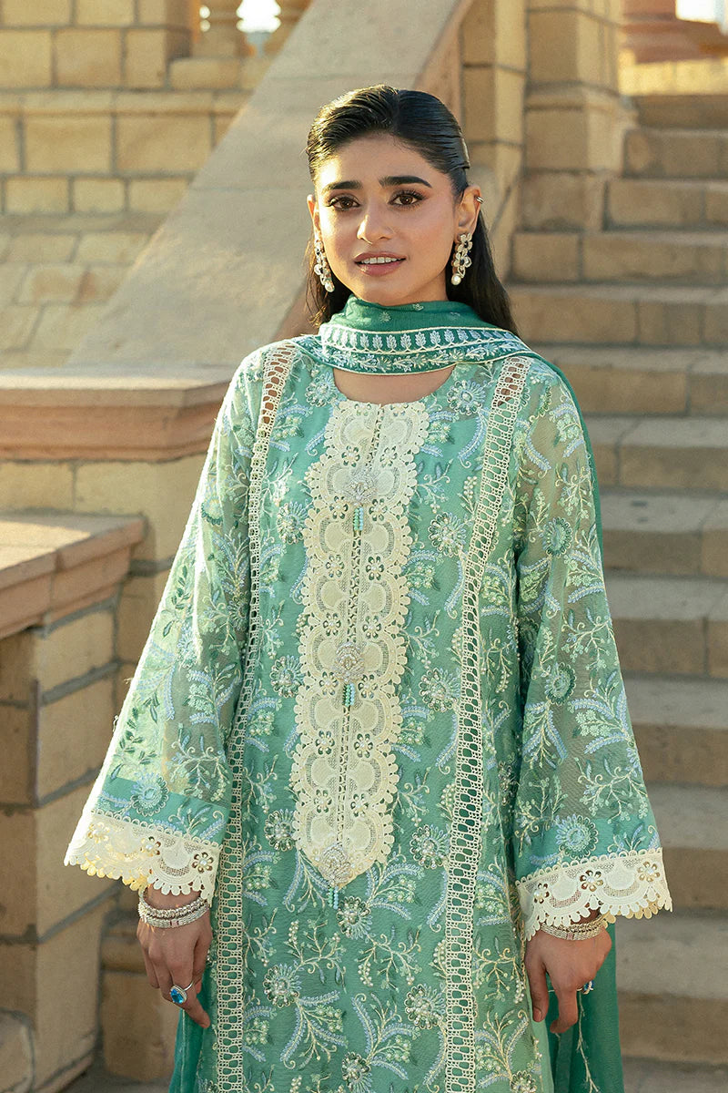 Model wearing Mushq Saugaat City of Lights Irsa in teal green with intricate embroidery. Shop Pakistani luxury pret online in the UK.