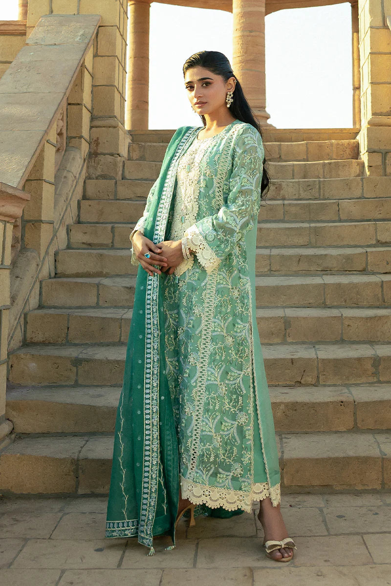 Model wearing Mushq Saugaat City of Lights Irsa in teal green with intricate embroidery. Shop Pakistani luxury pret online in the UK.