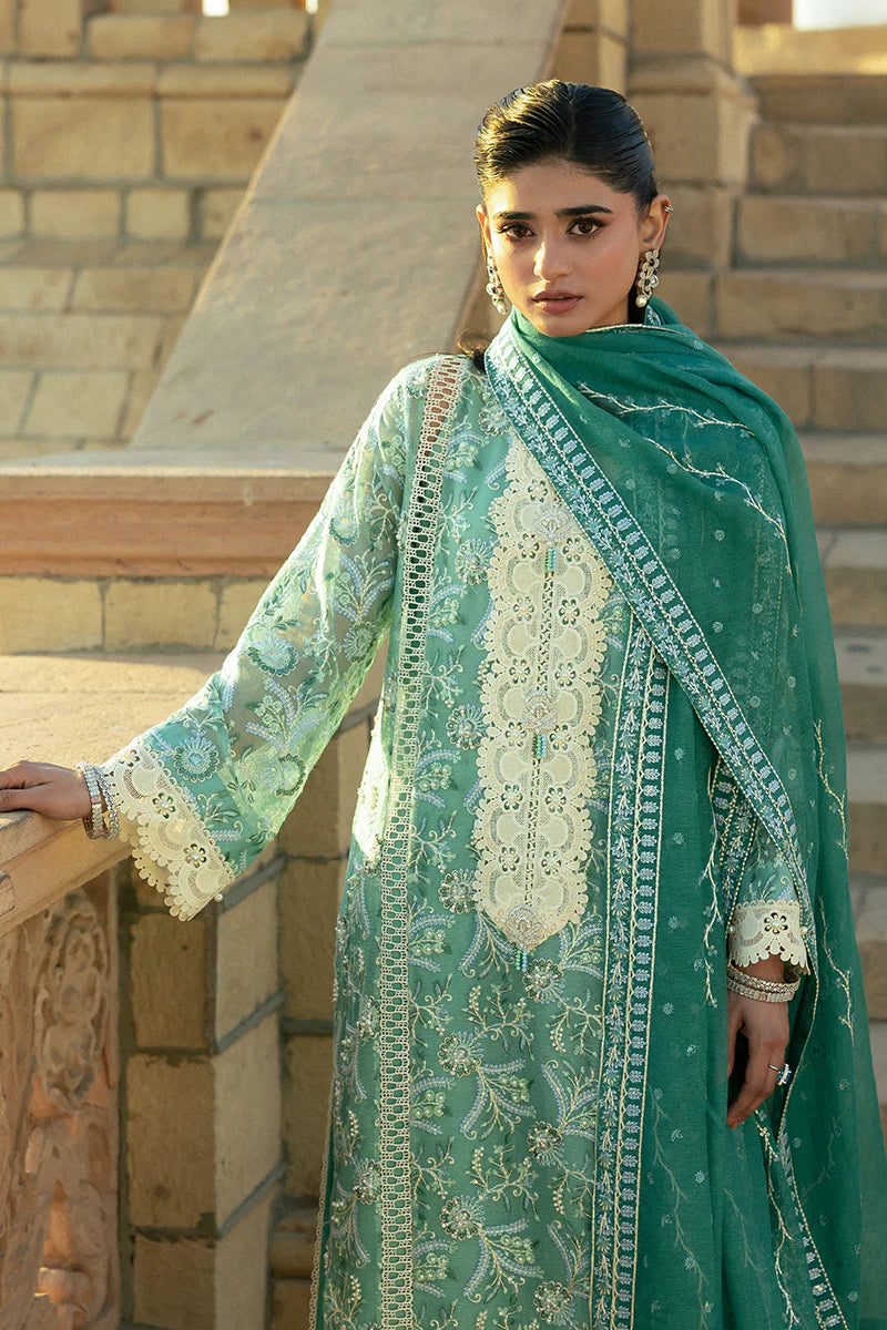 Model wearing Mushq Saugaat City of Lights Irsa in teal green with intricate embroidery. Shop Pakistani luxury pret online in the UK.