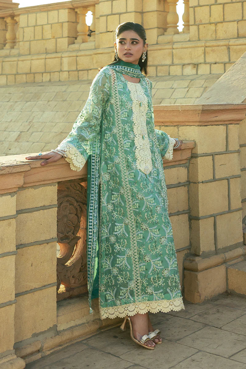 Model wearing Mushq Saugaat City of Lights Irsa in teal green with intricate embroidery. Shop Pakistani luxury pret online in the UK.