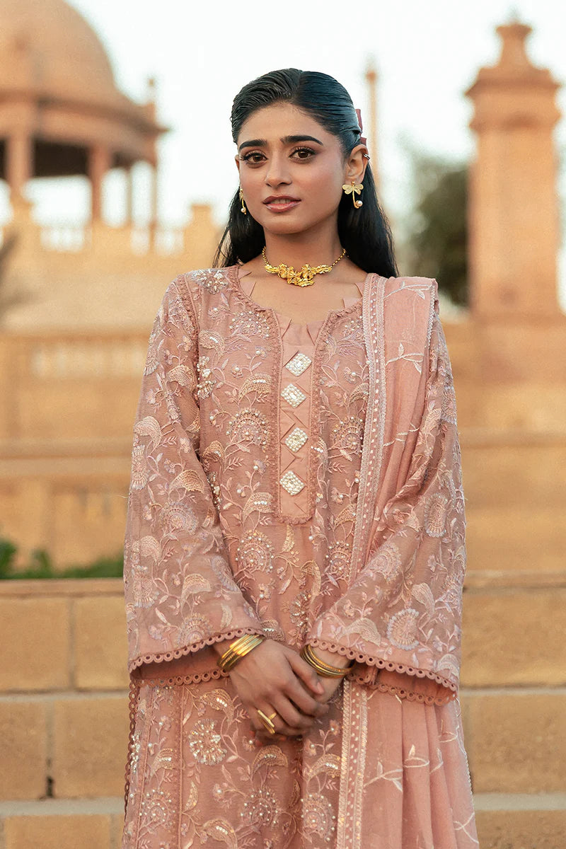 Model wearing Mushq Saugaat City of Lights Rabia in blush pink with delicate embroidery. Shop Pakistani luxury pret online in the UK.