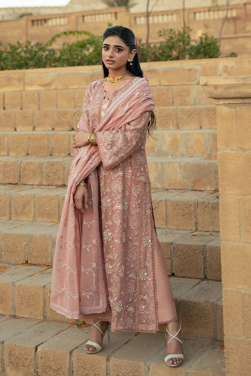 Model wearing Mushq Saugaat City of Lights Rabia in blush pink with delicate embroidery. Shop Pakistani luxury pret online in the UK.