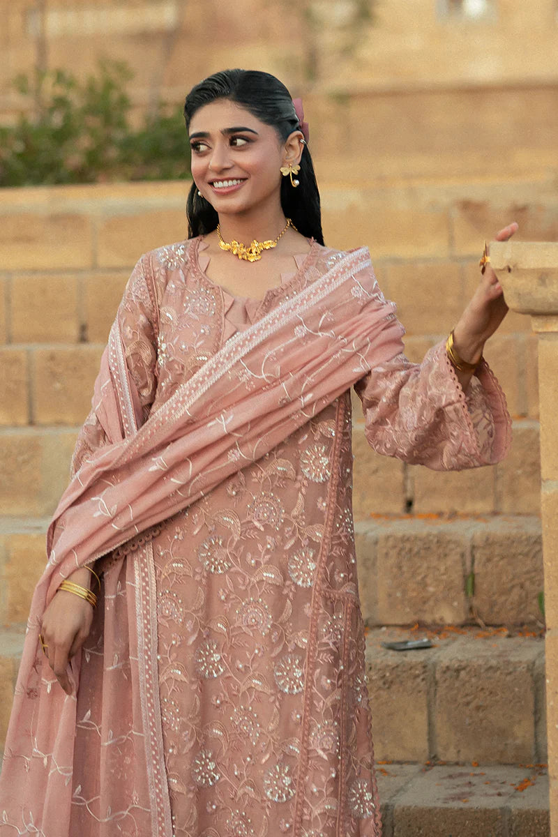 Model wearing Mushq Saugaat City of Lights Rabia in blush pink with delicate embroidery. Shop Pakistani luxury pret online in the UK.