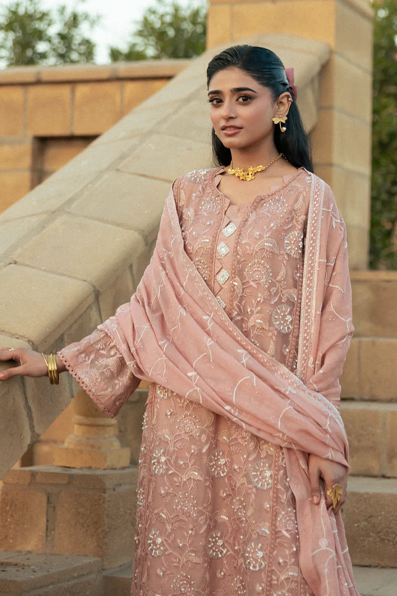 Model wearing Mushq Saugaat City of Lights Rabia in blush pink with delicate embroidery. Shop Pakistani luxury pret online in the UK.