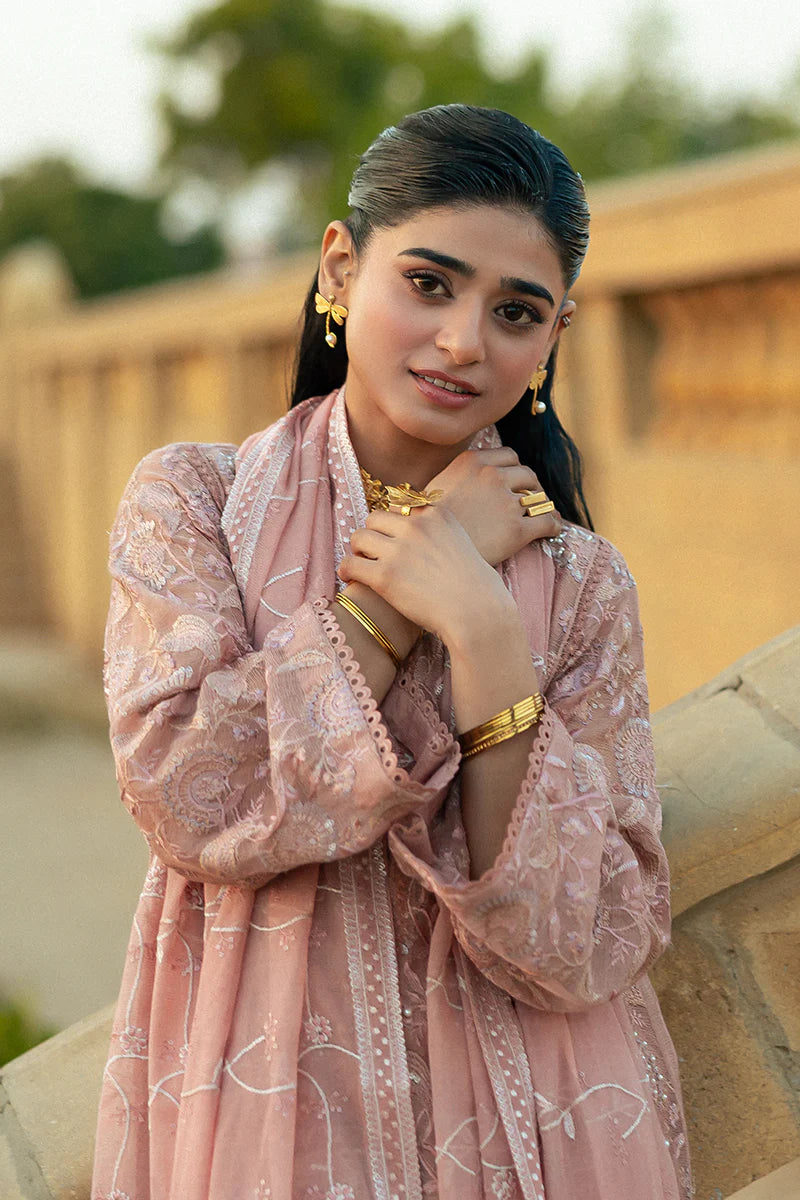 Model wearing Mushq Saugaat City of Lights Rabia in blush pink with delicate embroidery. Shop Pakistani luxury pret online in the UK.