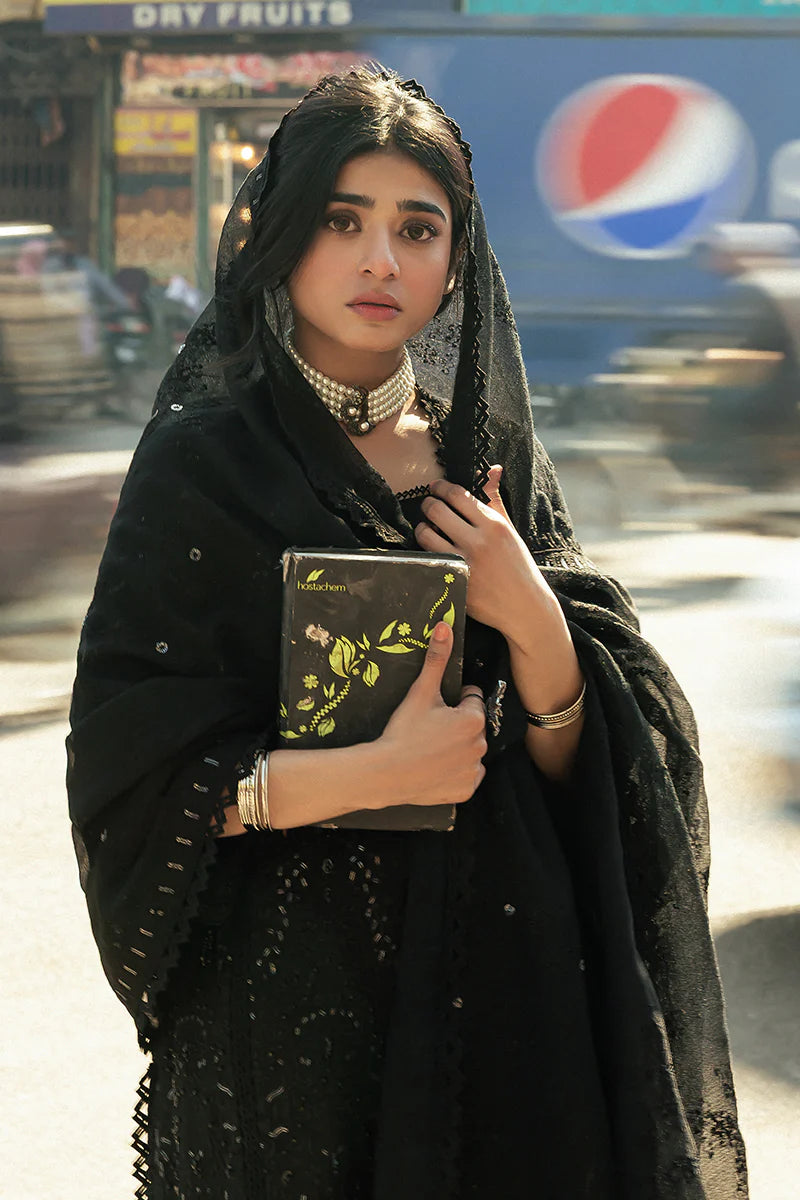 Model wearing Mushq Saugaat City of Lights Rija in black with intricate embellishments. Shop Pakistani luxury pret online in the UK.