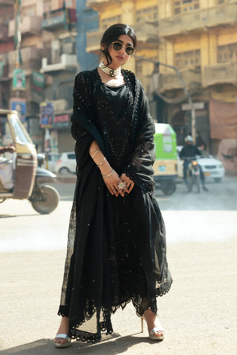 Model wearing Mushq Saugaat City of Lights Rija in black with intricate embellishments. Shop Pakistani luxury pret online in the UK.