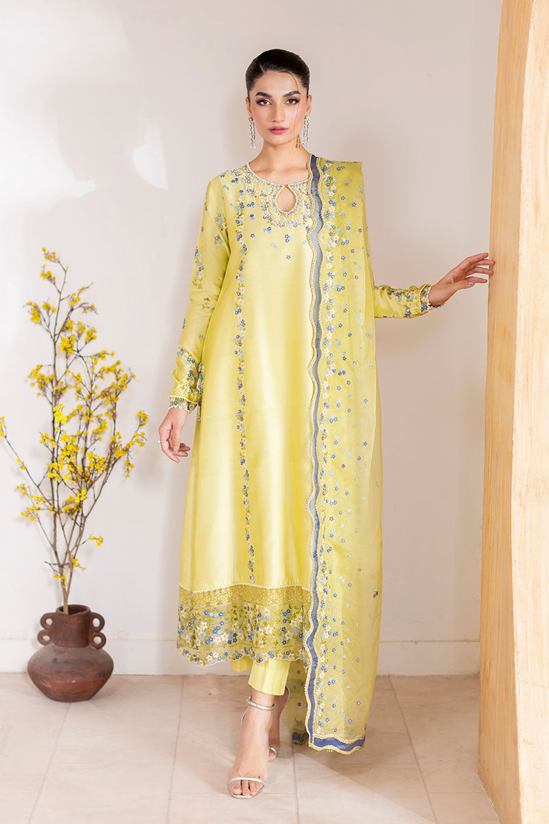 Model wearing lemon yellow Lumiere dress from Mushq with delicate blue embroidery, perfect for Pakistani luxury pret and clothes online in UK.
