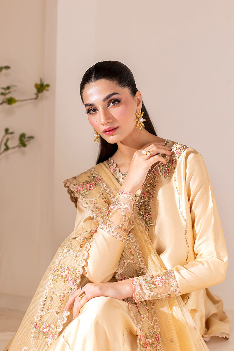 Model wearing golden Aurea dress from Mushq featuring intricate embellishments, ideal for Pakistani luxury pret and clothes online in UK.