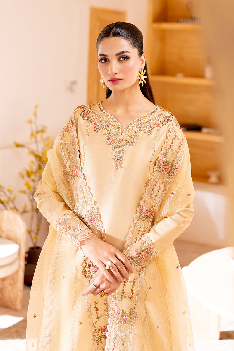 Model wearing golden Aurea dress from Mushq featuring intricate embellishments, ideal for Pakistani luxury pret and clothes online in UK.