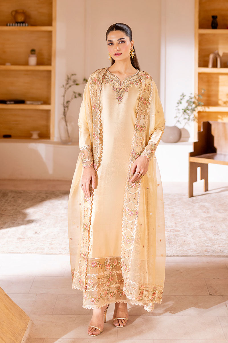 Model wearing golden Aurea dress from Mushq featuring intricate embellishments, ideal for Pakistani luxury pret and clothes online in UK.