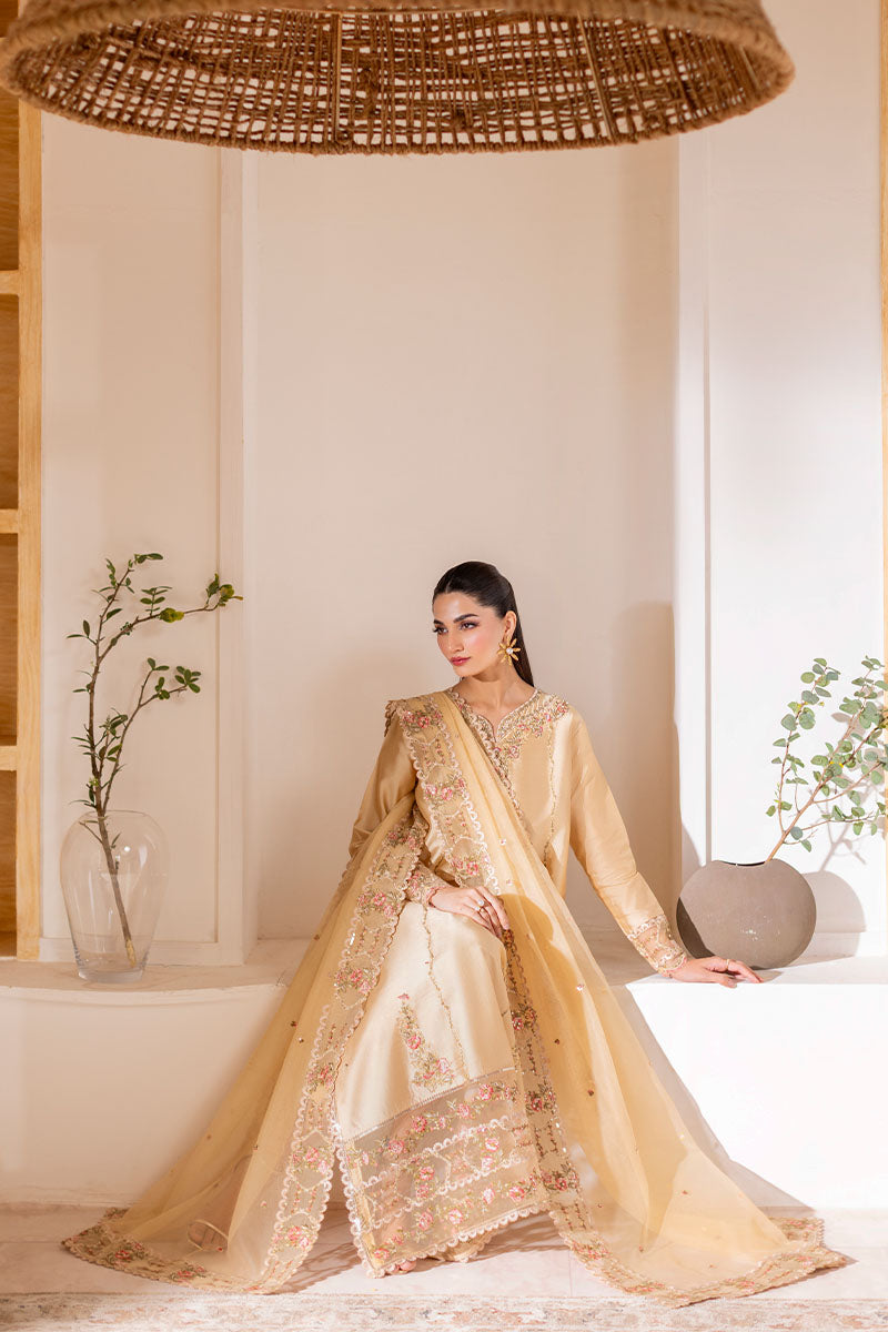 Model wearing golden Aurea dress from Mushq featuring intricate embellishments, ideal for Pakistani luxury pret and clothes online in UK.