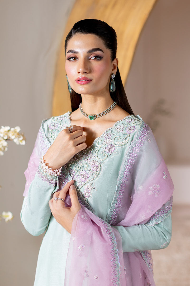 Model wearing mint green and lilac embroidered outfit Solstice from Mushq, showcasing Pakistani luxury pret and clothes online in UK.
