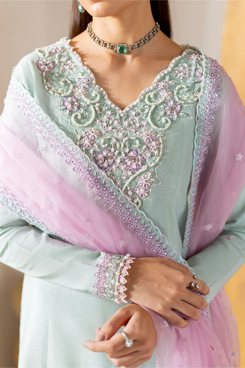 Model wearing mint green and lilac embroidered outfit Solstice from Mushq, showcasing Pakistani luxury pret and clothes online in UK.
