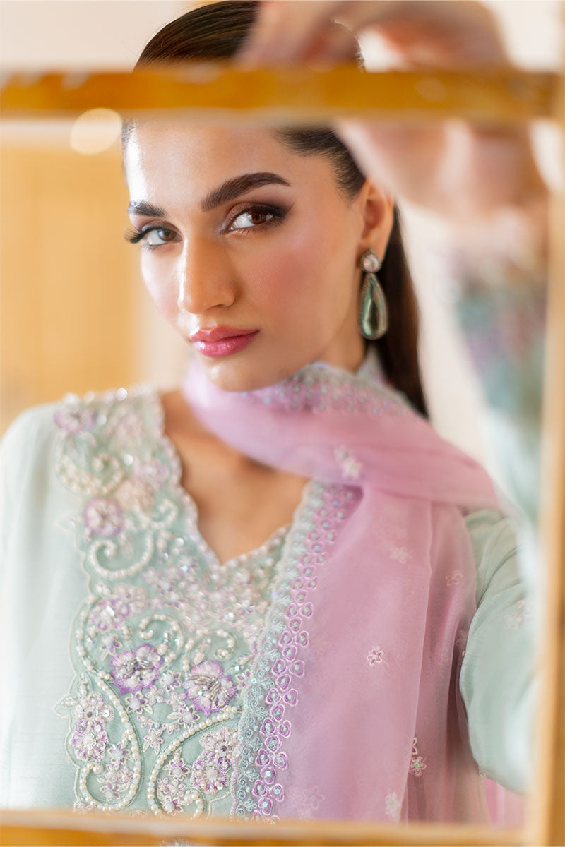 Model wearing mint green and lilac embroidered outfit Solstice from Mushq, showcasing Pakistani luxury pret and clothes online in UK.
