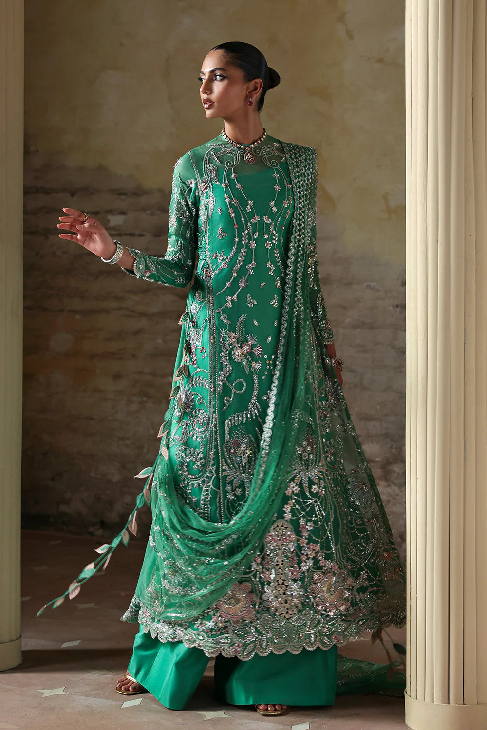 Model wearing Maristella by Soraya in emerald green with silver embellishments – Pakistani luxury pret, shop Soraya clothes online in UK.
