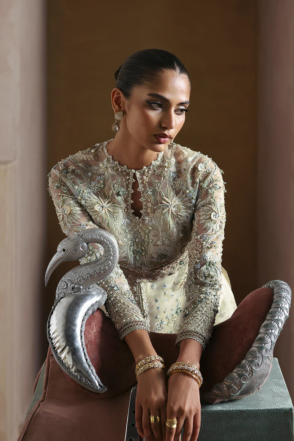 Model wearing Novara by Soraya in ivory with silver and pastel embroidery – Pakistani luxury pret, shop Soraya clothes online in UK.
