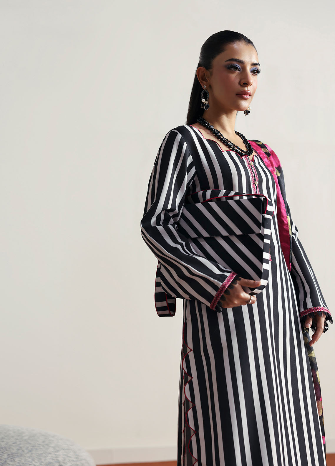 Model wearing black and white striped outfit with floral dupatta from Gulaal Basics | Fleuron, ideal Pakistani luxury pret in UK.
