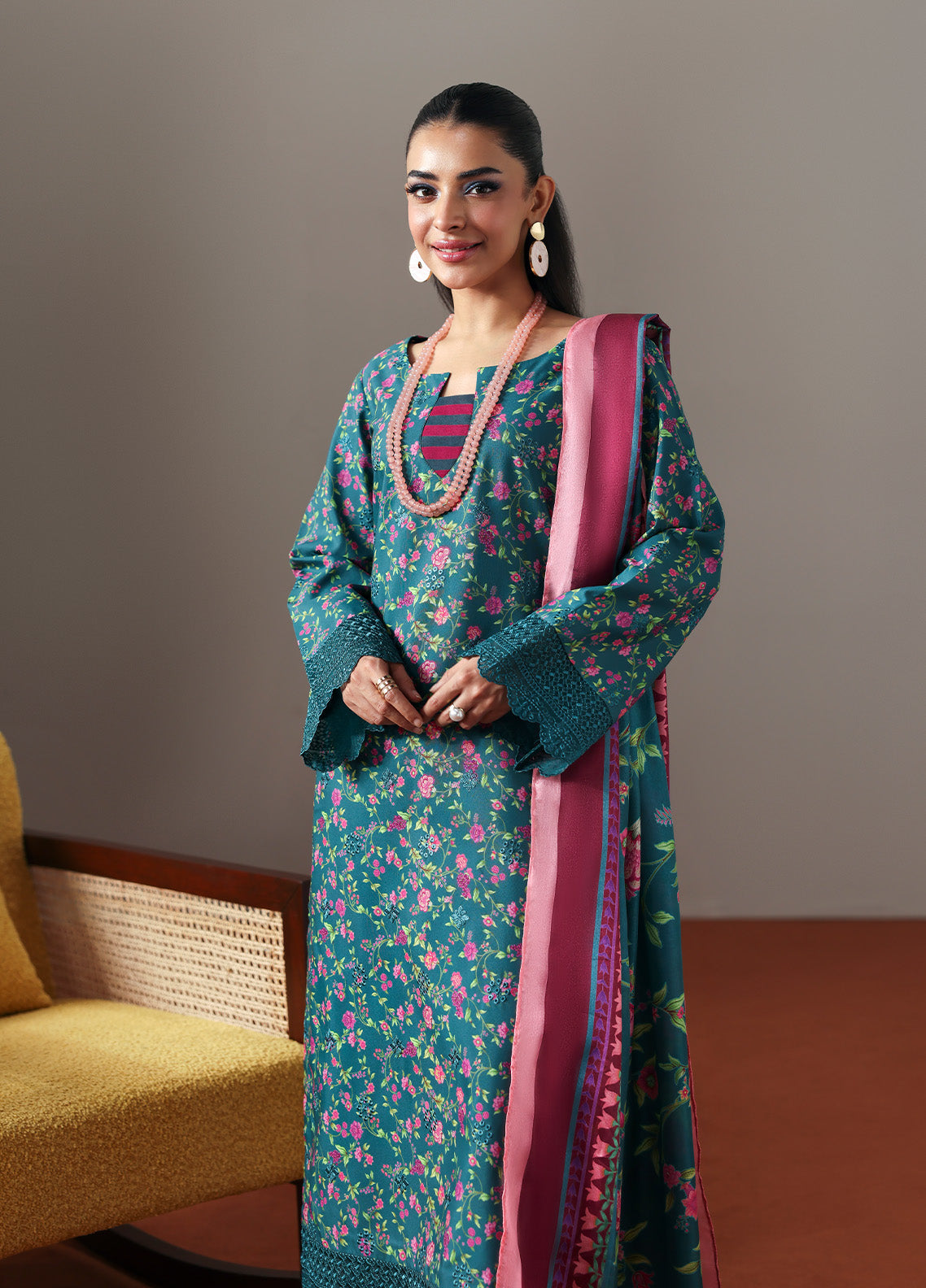 Model wearing Zeirin from Gulaal in a teal green floral printed co-ord set with pink dupatta, ideal for Pakistani luxury pret in the UK.