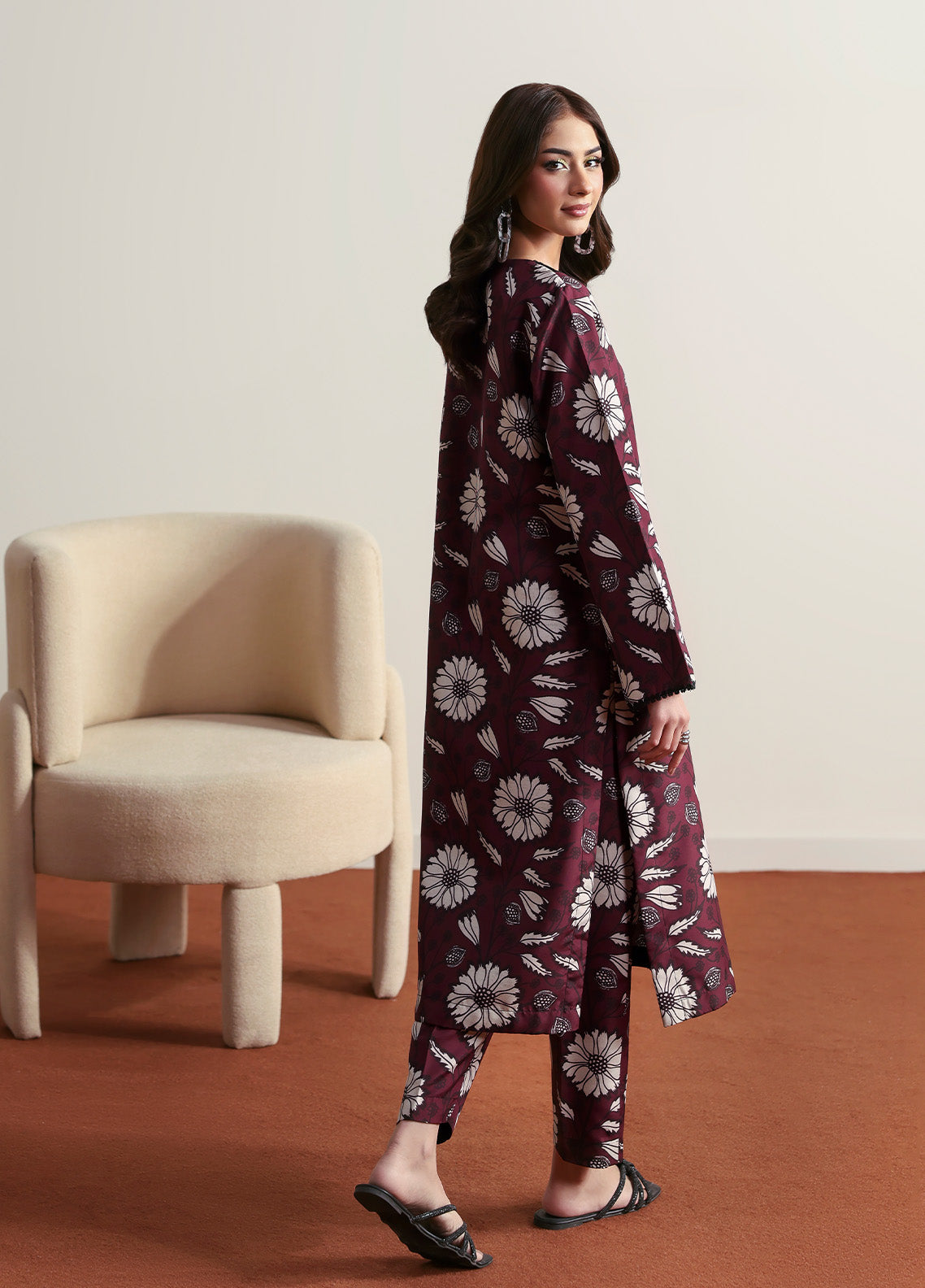 Model wearing Evra from Gulaal in a deep maroon printed co-ord set with bold white floral patterns, perfect for Pakistani luxury pret in the UK.